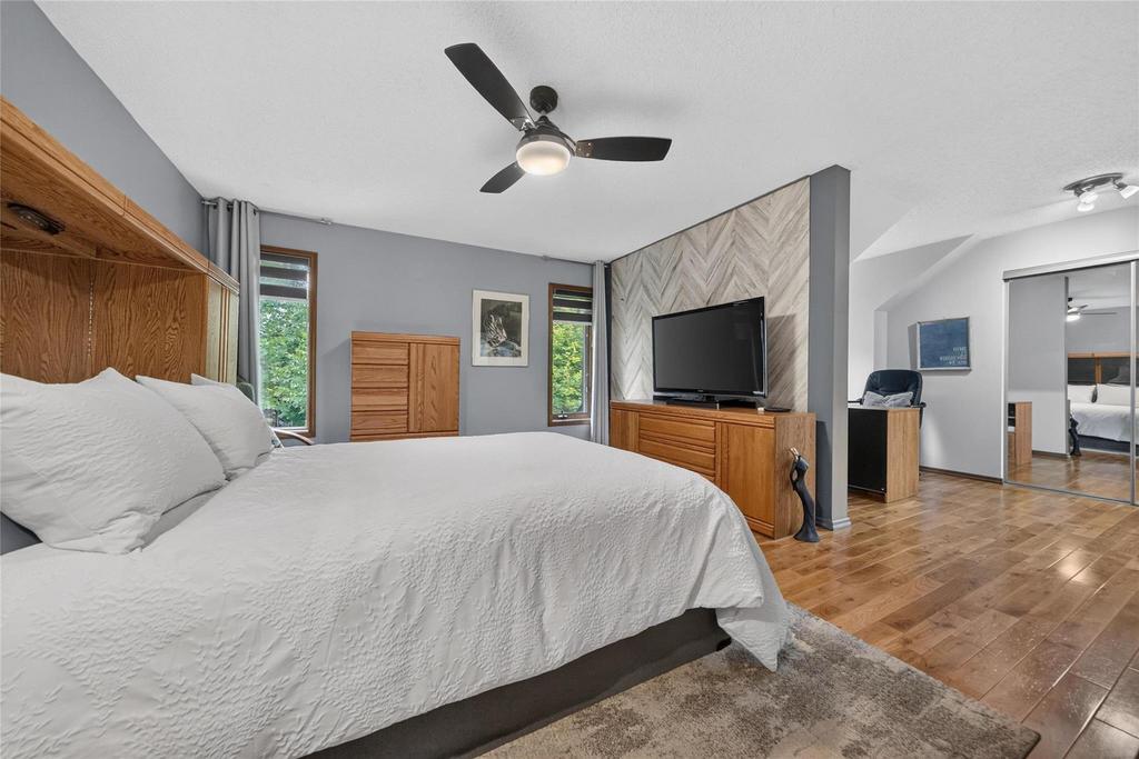 Extra-large primary bedroom with hardwood floors