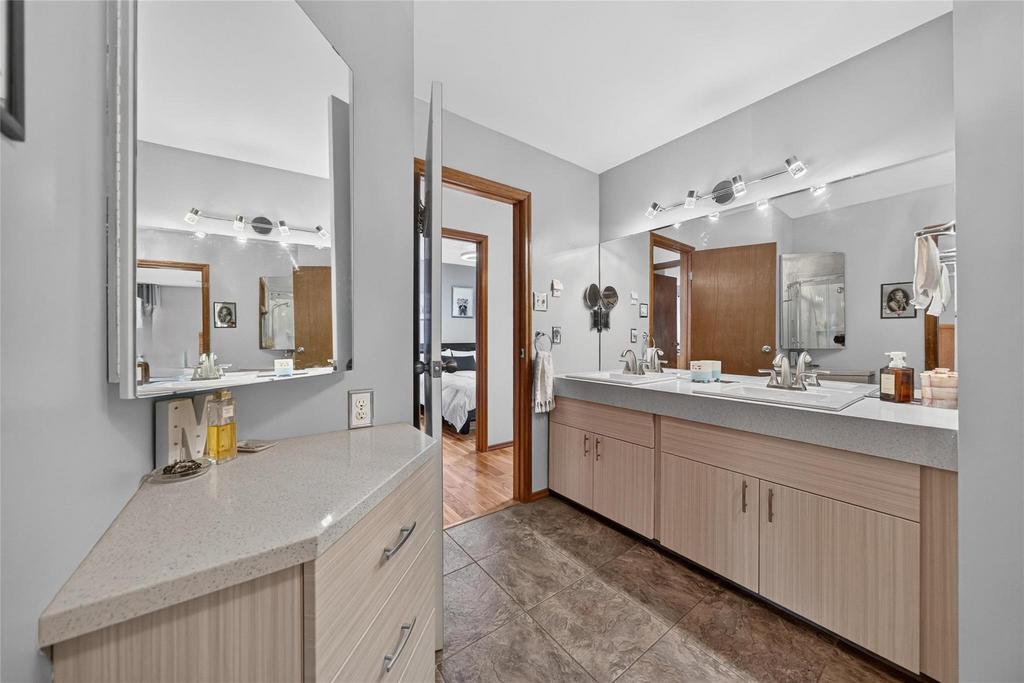Six-piece ensuite with quartz double vanity, separate tub and shower